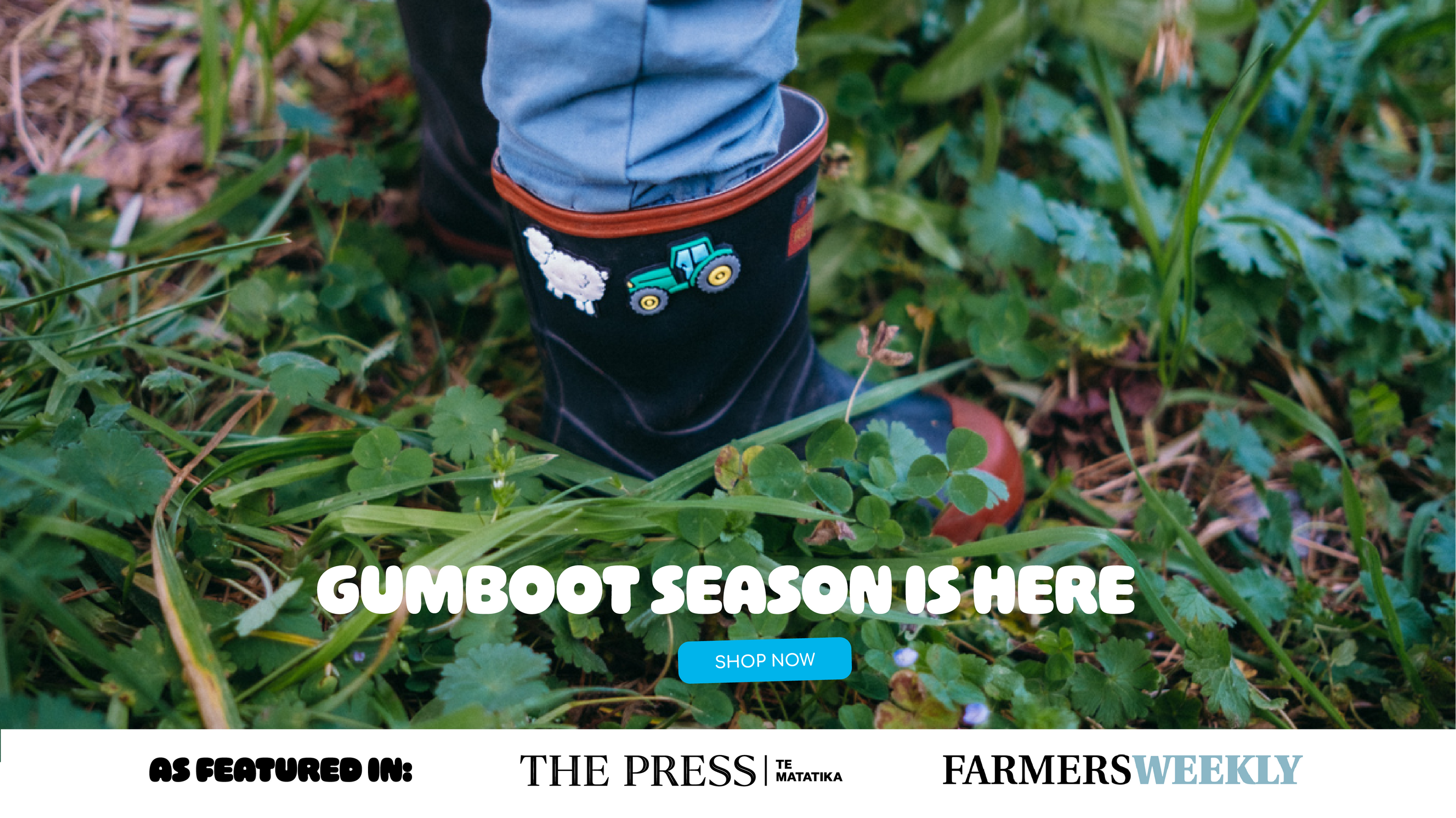 Child's foot in a gumboot with sheep and tractor Gumbitz on grass, featuring text 'Gumboot Season is Here' and brand mentions.